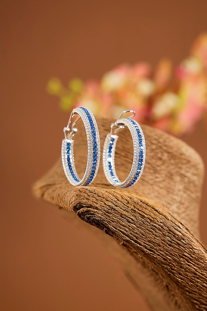 White Gold Finish Zircon & Sapphire Stone Hoop Earrings In Sterling Silver by STELLA CREATIONS at Pernia's Pop Up Shop