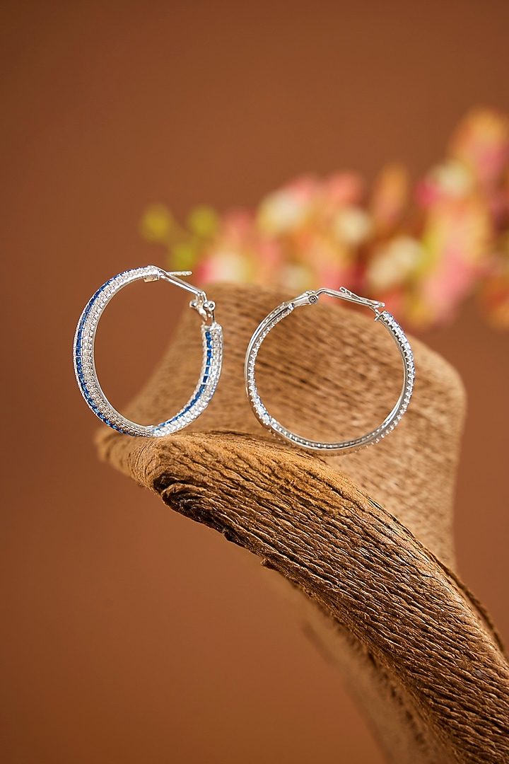 White Gold Finish Zircon & Sapphire Stone Hoop Earrings In Sterling Silver by STELLA CREATIONS at Pernia's Pop Up Shop