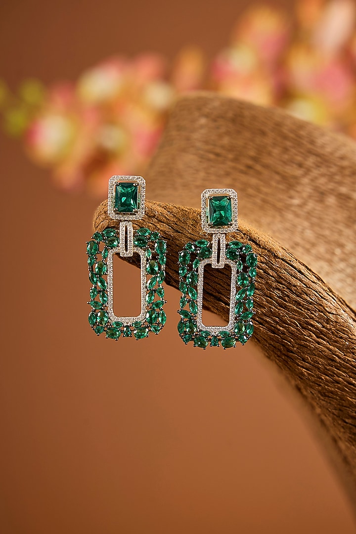White Gold Finish Zircon & Emerald Stone Dangler Earrings In Sterling Silver by STELLA CREATIONS at Pernia's Pop Up Shop