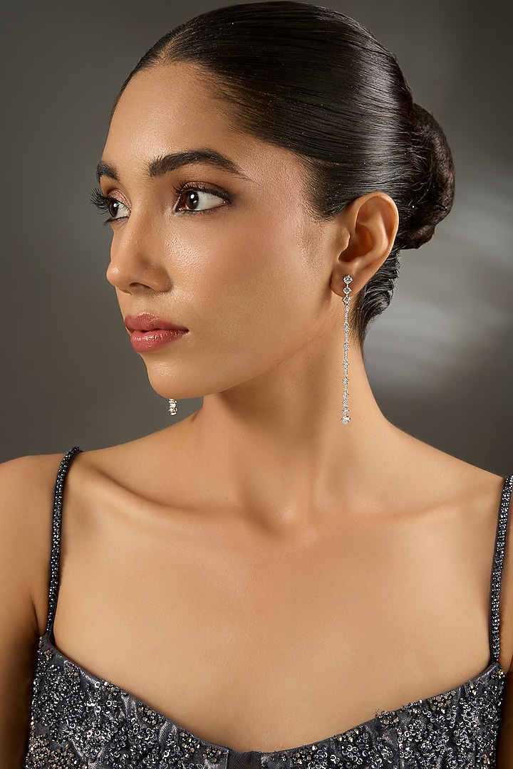 White Finish Eurostar Zircon Dangler Earrings In Sterling Silver by STELLA CREATIONS at Pernia's Pop Up Shop