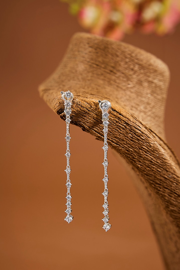 White Finish Eurostar Zircon Dangler Earrings In Sterling Silver by STELLA CREATIONS at Pernia's Pop Up Shop
