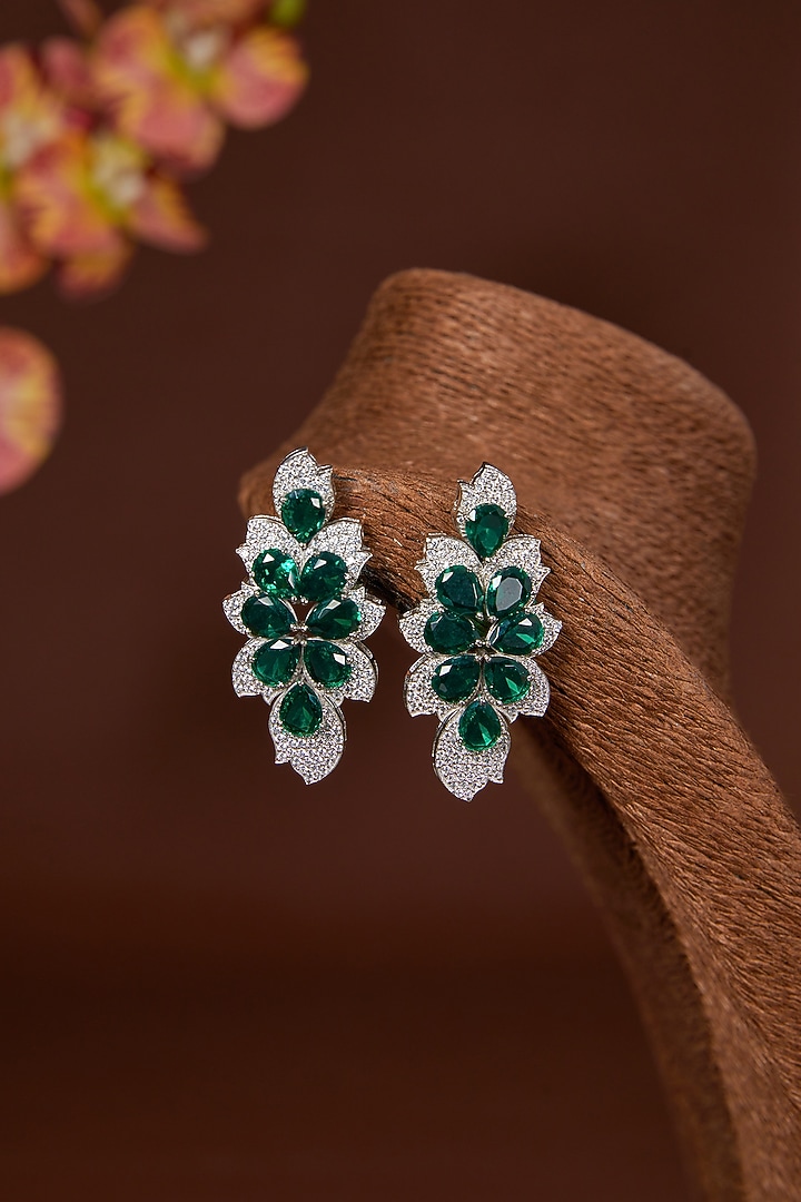 White Finish Zircon & Emerald Dangler Earrings In Sterling Silver by STELLA CREATIONS at Pernia's Pop Up Shop