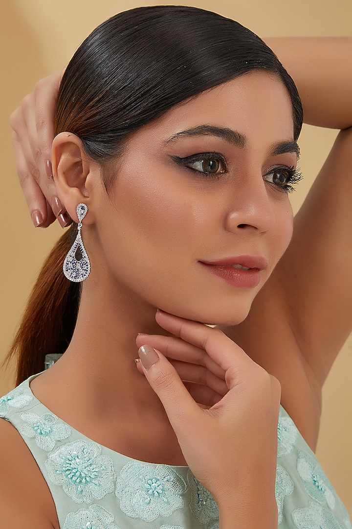 White Finish Zircon & Blue Sapphire Dangler Earrings In Sterling Silver by STELLA CREATIONS at Pernia's Pop Up Shop