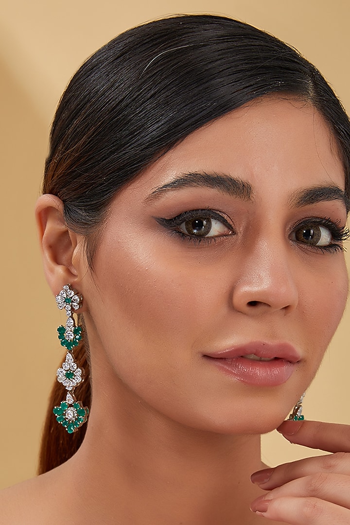 White Finish Zircon & Synthetic Emerald Dangler Earrings In Sterling Silver by STELLA CREATIONS at Pernia's Pop Up Shop