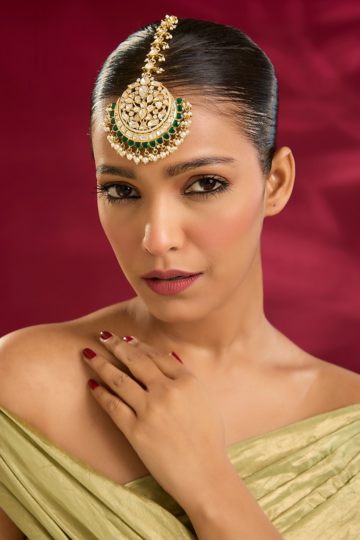 Yellow Gold Finish Moissanite Polki & Emerald Stone Maangtikka In Sterling Silver by STELLA CREATIONS at Pernia's Pop Up Shop
