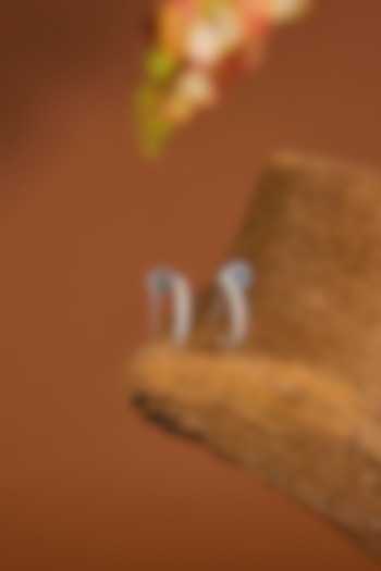 White Gold Finish Zircon Hoop Earrings In Sterling Silver by STELLA CREATIONS at Pernia's Pop Up Shop