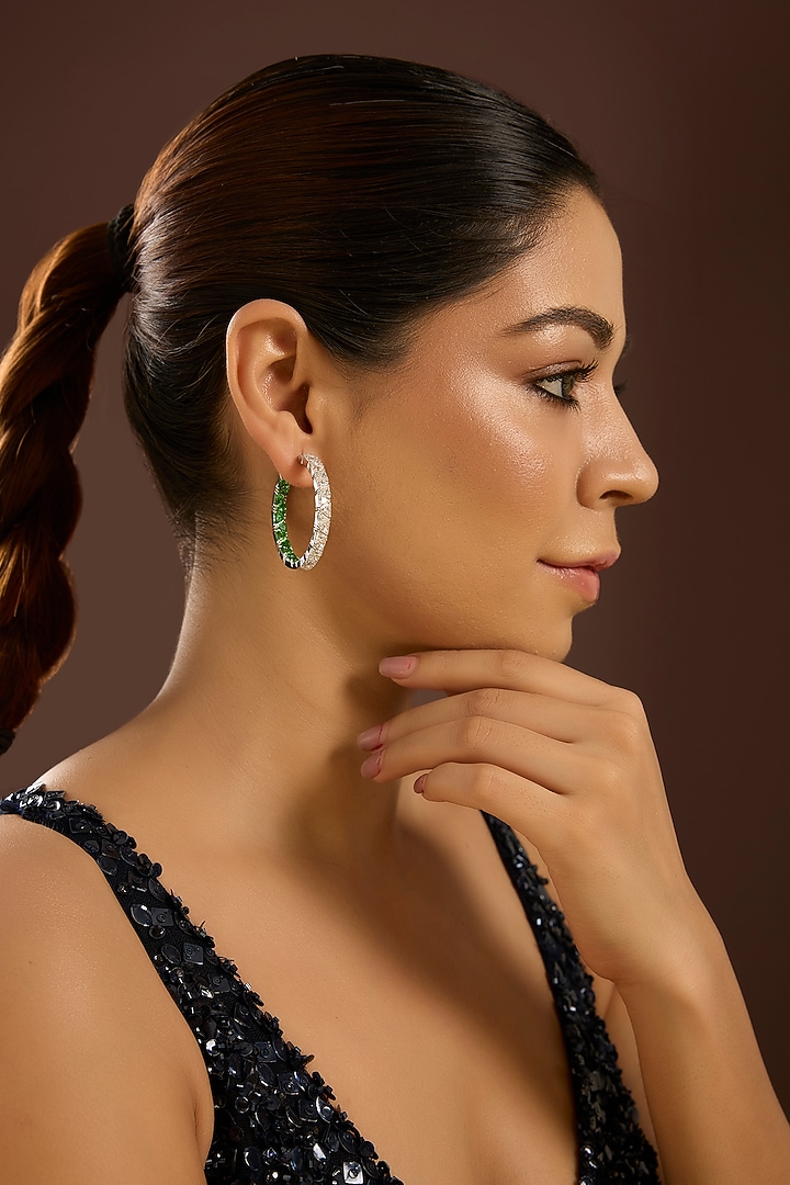 White Gold Finish Zircon & Emerald Stone Hoop Earrings In Sterling Silver by STELLA CREATIONS at Pernia's Pop Up Shop