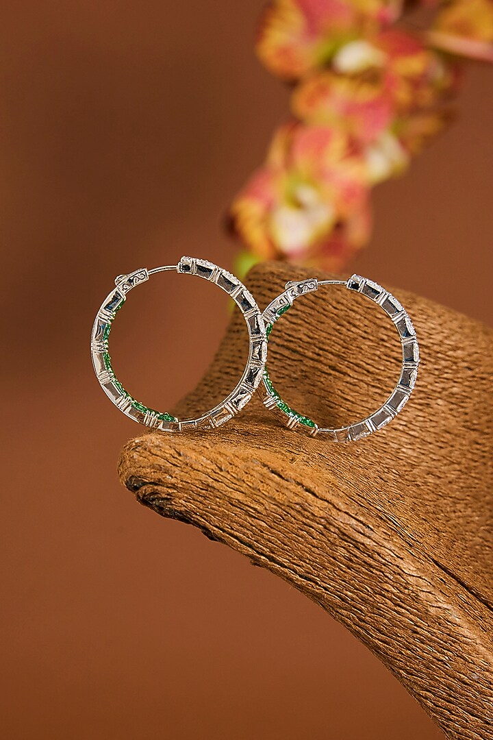 White Gold Finish Zircon & Emerald Stone Hoop Earrings In Sterling Silver by STELLA CREATIONS at Pernia's Pop Up Shop