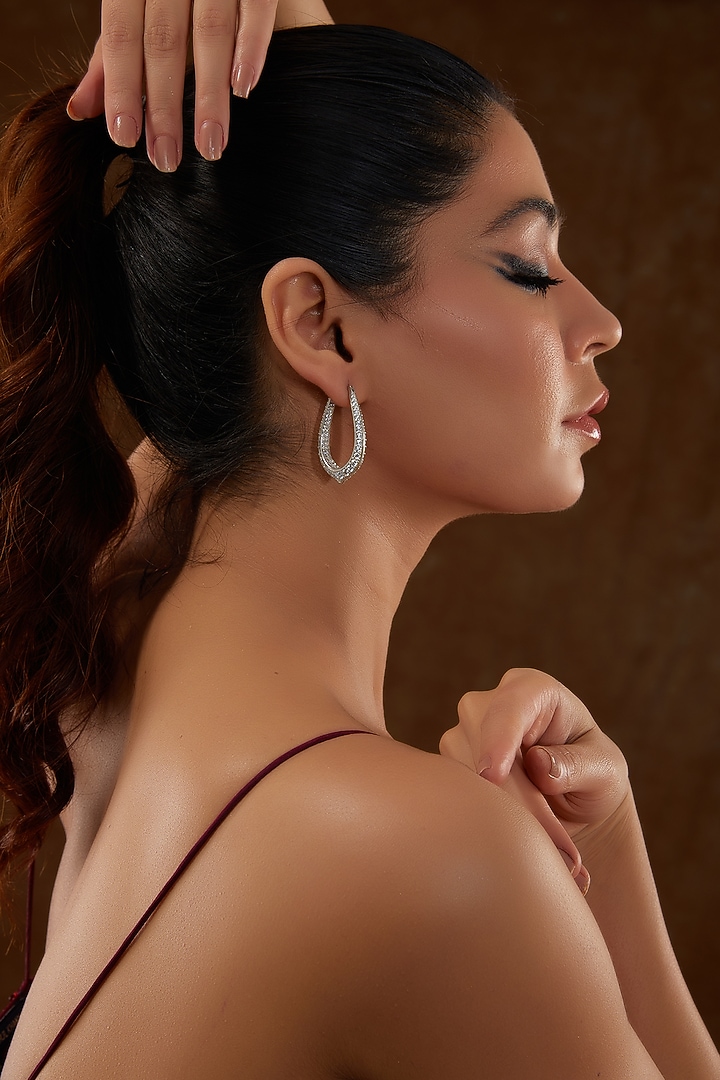 White Gold Finish Zircon Hoop Earrings In Sterling Silver by STELLA CREATIONS at Pernia's Pop Up Shop