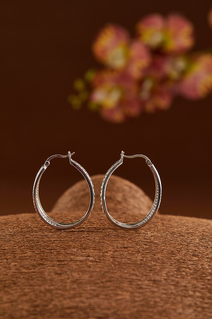 White Gold Finish Zircon Hoop Earrings In Sterling Silver by STELLA CREATIONS at Pernia's Pop Up Shop