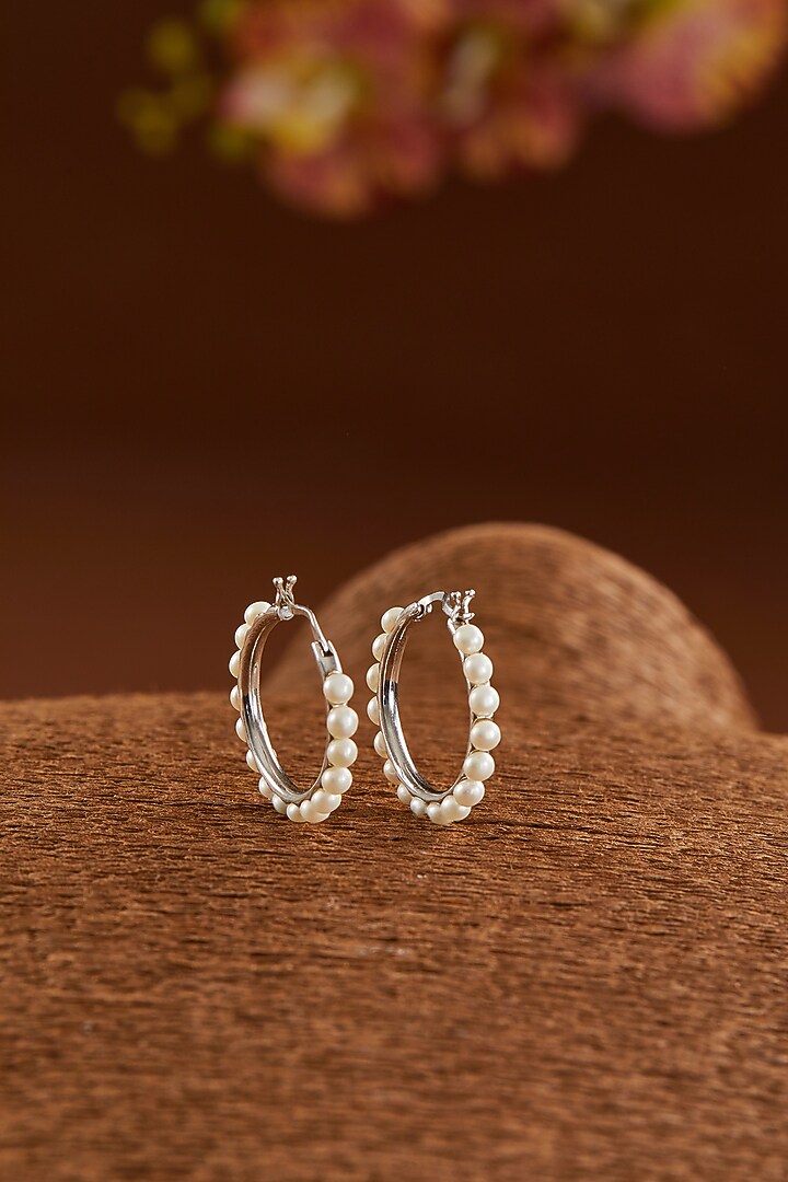 White Gold Finish Zircon & Pearl Hoop Earrings In Sterling Silver by STELLA CREATIONS at Pernia's Pop Up Shop