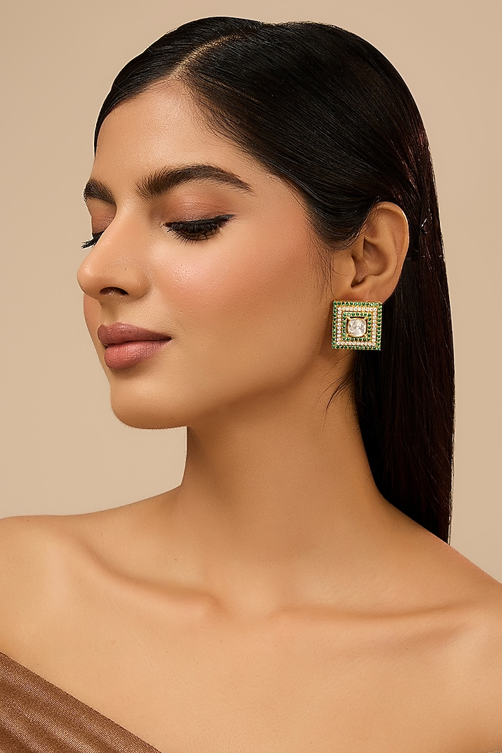 Yellow Gold Finish Moissanite Polki & Glass-Filled Emerald Stone Stud Earrings In Sterling Silver by STELLA CREATIONS at Pernia's Pop Up Shop