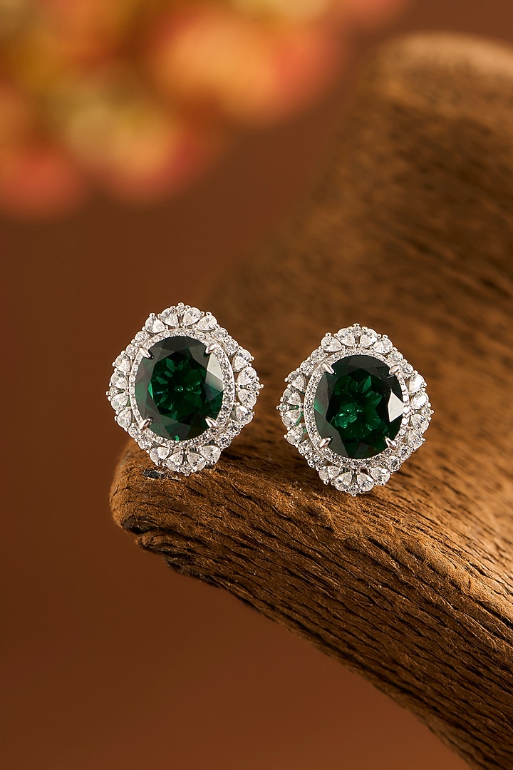 White Gold Finish Eurostar Zircons & Glass-Filled Emerald Stone Stud Earrings In Sterling Silver by STELLA CREATIONS at Pernia's Pop Up Shop