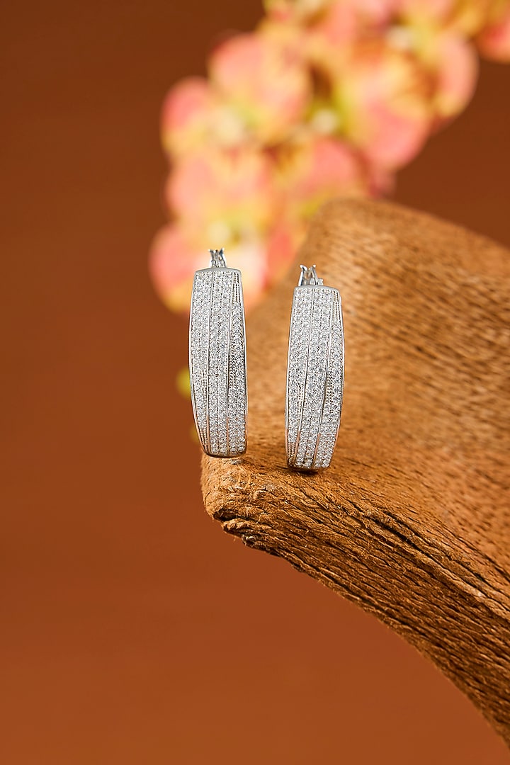 White Gold Finish Eurostar Zircon Hoop Earrings In Sterling Silver by STELLA CREATIONS at Pernia's Pop Up Shop