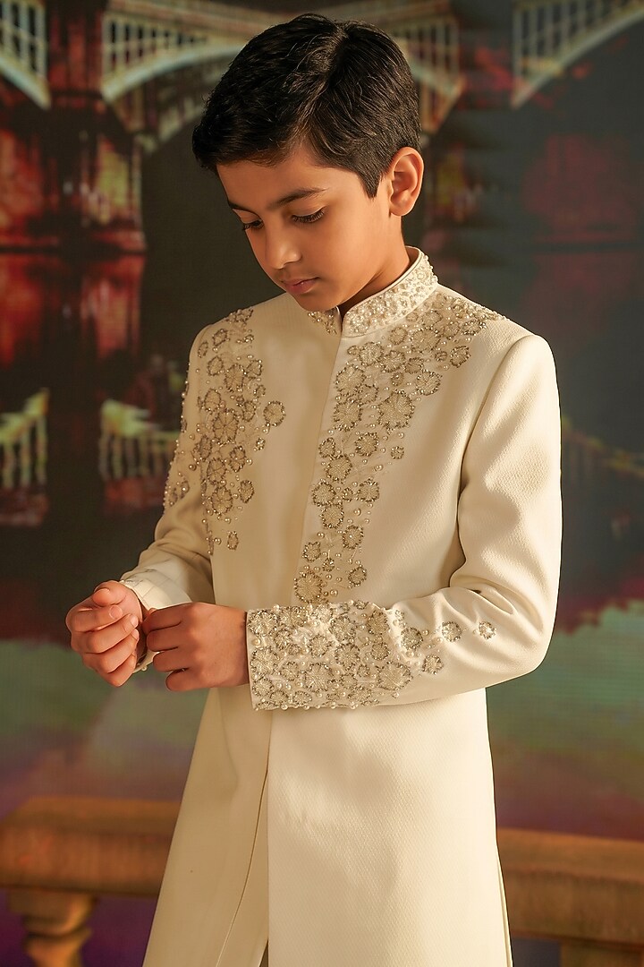 Cream Textured Suiting Hand Embroidered Indowestern Set For Boys by STEEL kids at Pernia's Pop Up Shop