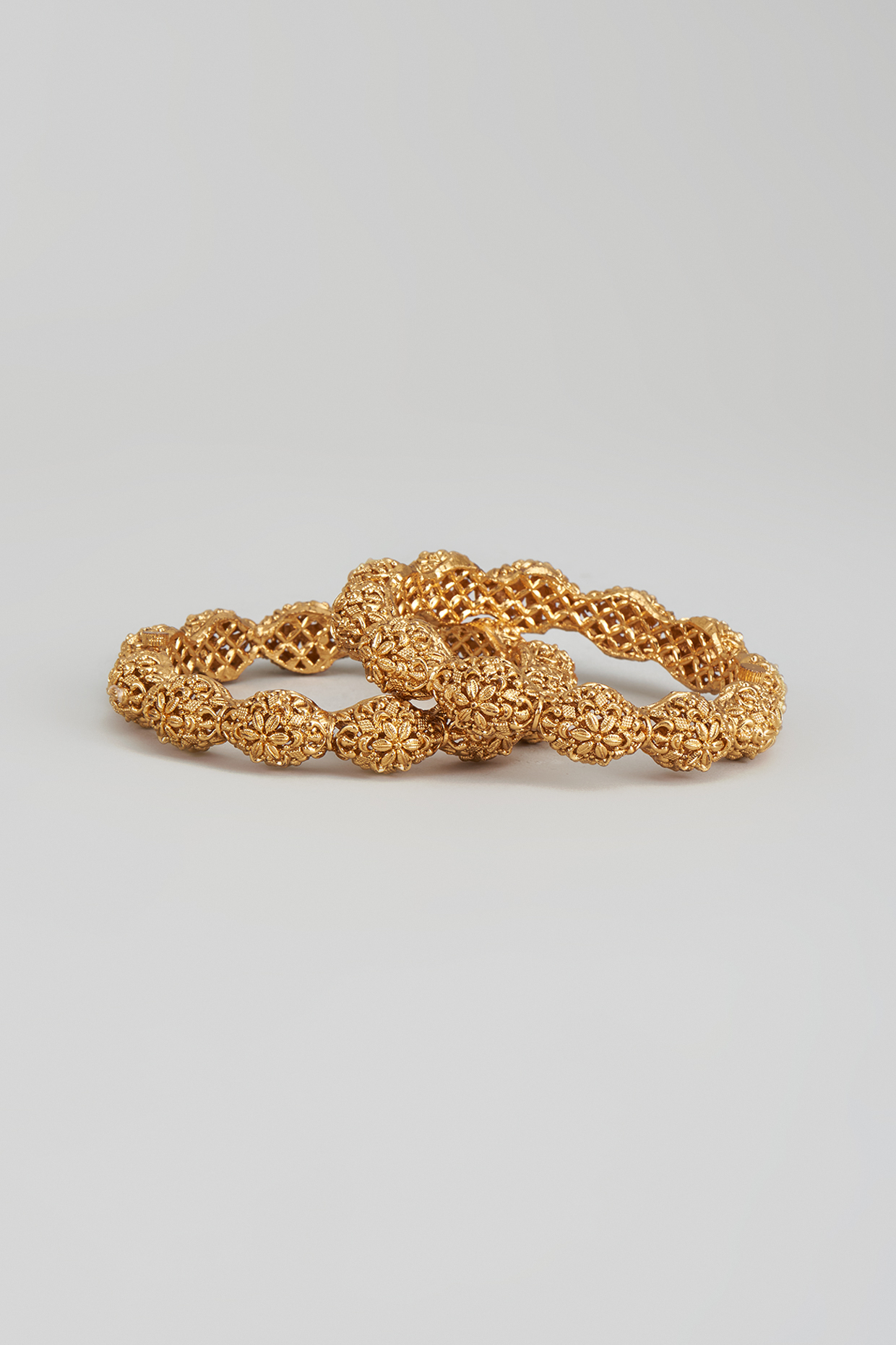 Gold Finish Carved Temple Bangles (Set of 2) by Studio6 Jewels at Pernia's Pop Up Shop