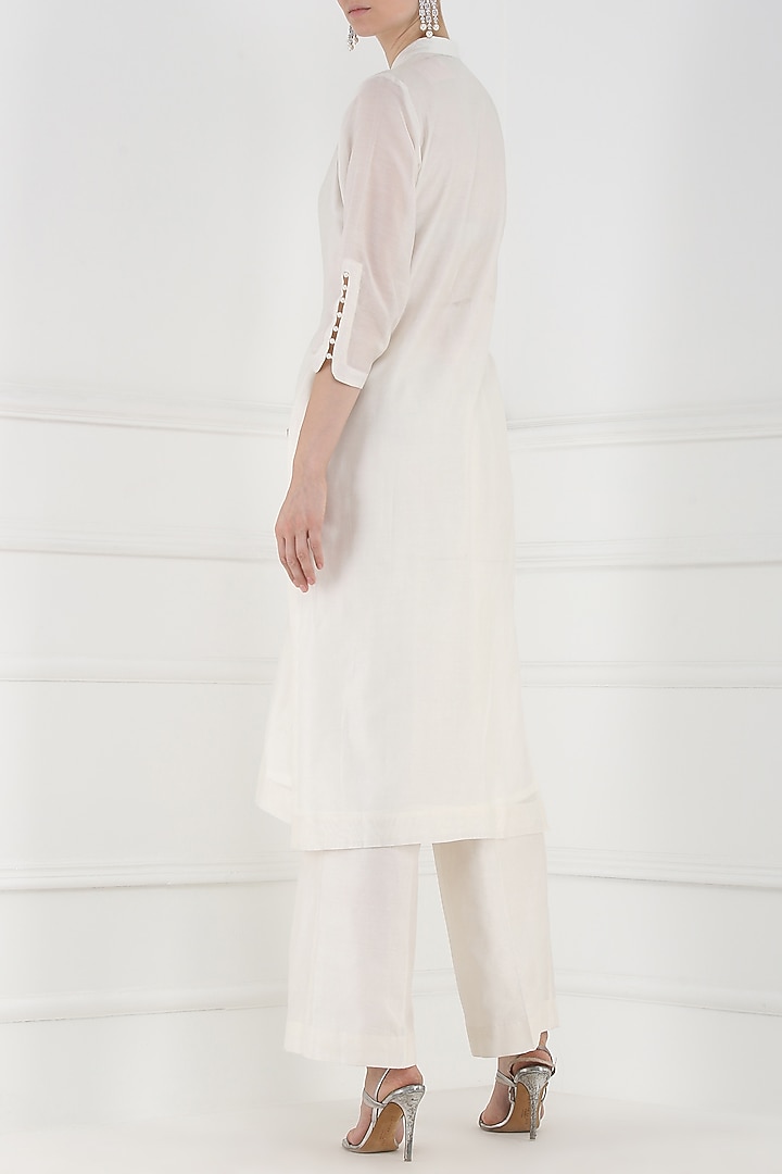 White embroidered and tassel buttons kurta and palazzo pants set available only at Pernia's Pop Up Shop.