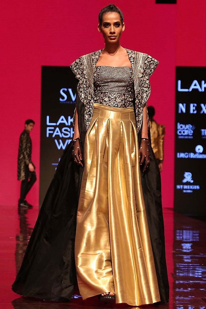Black Corset Bustier With Cape & Gold Pleated Skirt by SVA BY SONAM & PARAS MODI
