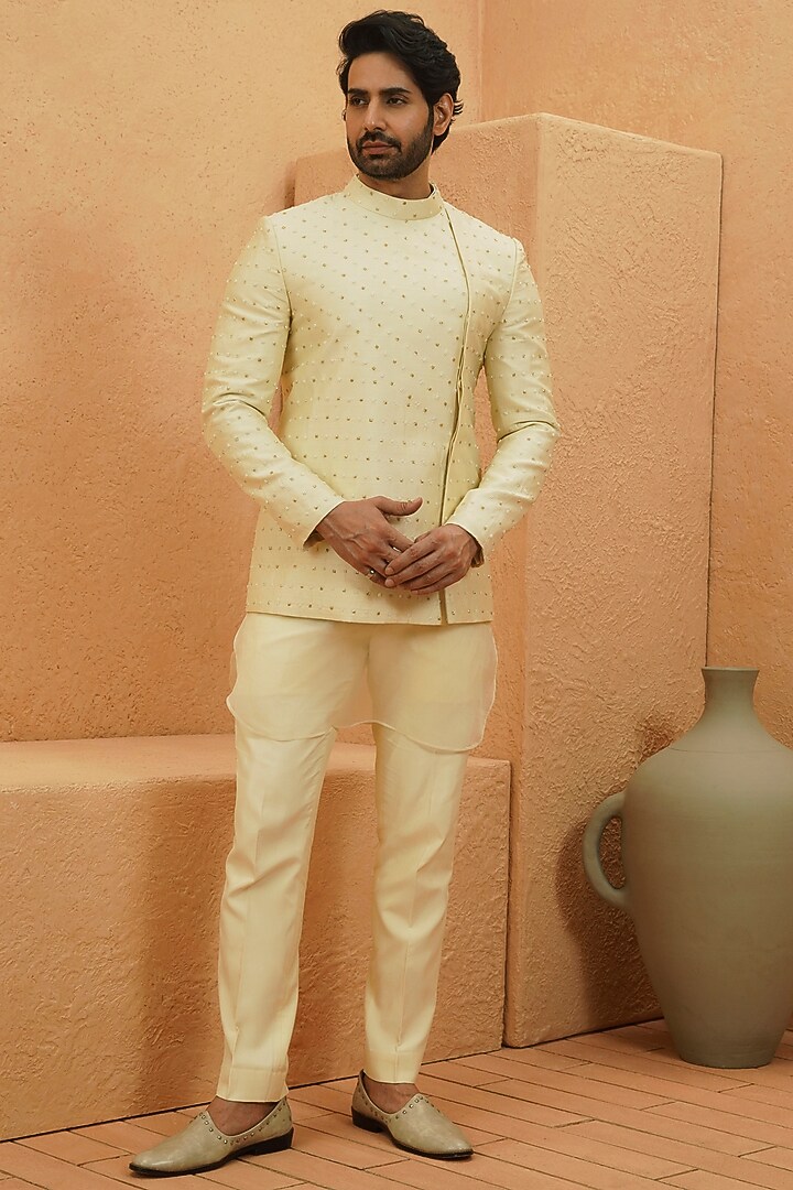 Ivory Silk Gold Embellished Asymmetric Bandhgala Jacket by Sva By Sonam & Paras Modi Men at Pernia's Pop Up Shop