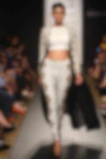 White crop top with high waisted pitta work pants and jacket available only at Pernia's Pop-Up Shop.