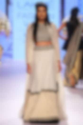 Off-white handwoven lehenga with embellished crop top and dye cut jacket available only at Pernia's Pop-Up Shop.