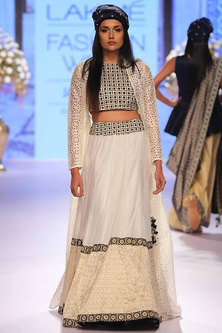Off-white handwoven lehenga with embellished crop top and dye cut jacket available only at Pernia's Pop-Up Shop.
