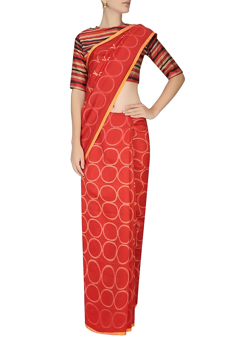 Red and yellow printed saree with black striped crop top available only at Pernia's Pop Up Shop.