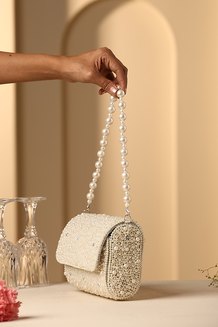 Beige Velvet Crystal & Pearl Embellished Hand Bag by SWABHIMANN ACCESSORIES at Pernia's Pop Up Shop
