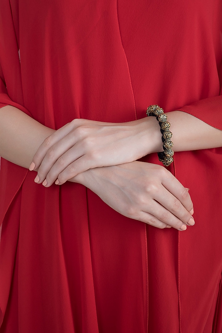 Gold Finish Metal Balls Antique Bracelet by Tanvi Garg at Pernia's Pop Up Shop