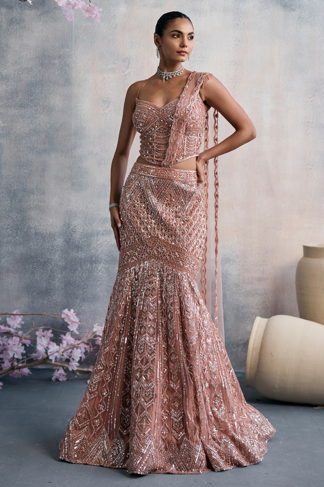 Tanaksh Peach Net Sequins Embroidered Fish-Cut Draped Lehenga Set