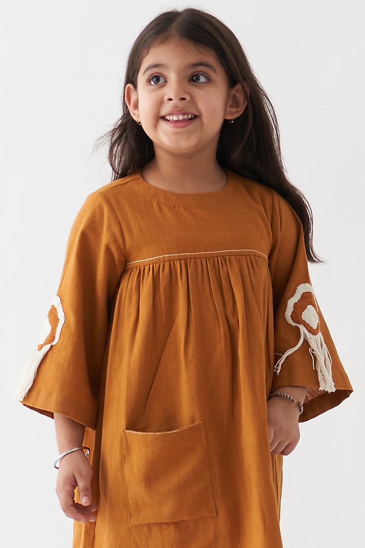 Rust Handwoven Cotton Dress For Girls by Three Kidswear at Pernia's Pop Up Shop