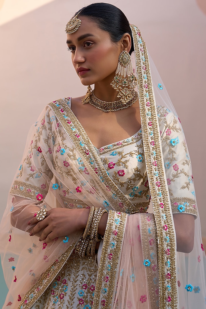 Ivory Raw Silk Applique Embroidered Wedding Lehenga Set by Angad Singh at Pernia's Pop Up Shop