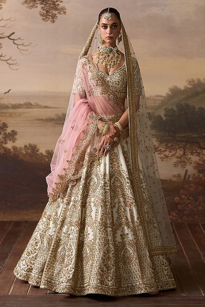 Ivory Raw Silk Floral Embroidered Bridal Lehenga Set by Angad Singh at Pernia's Pop Up Shop
