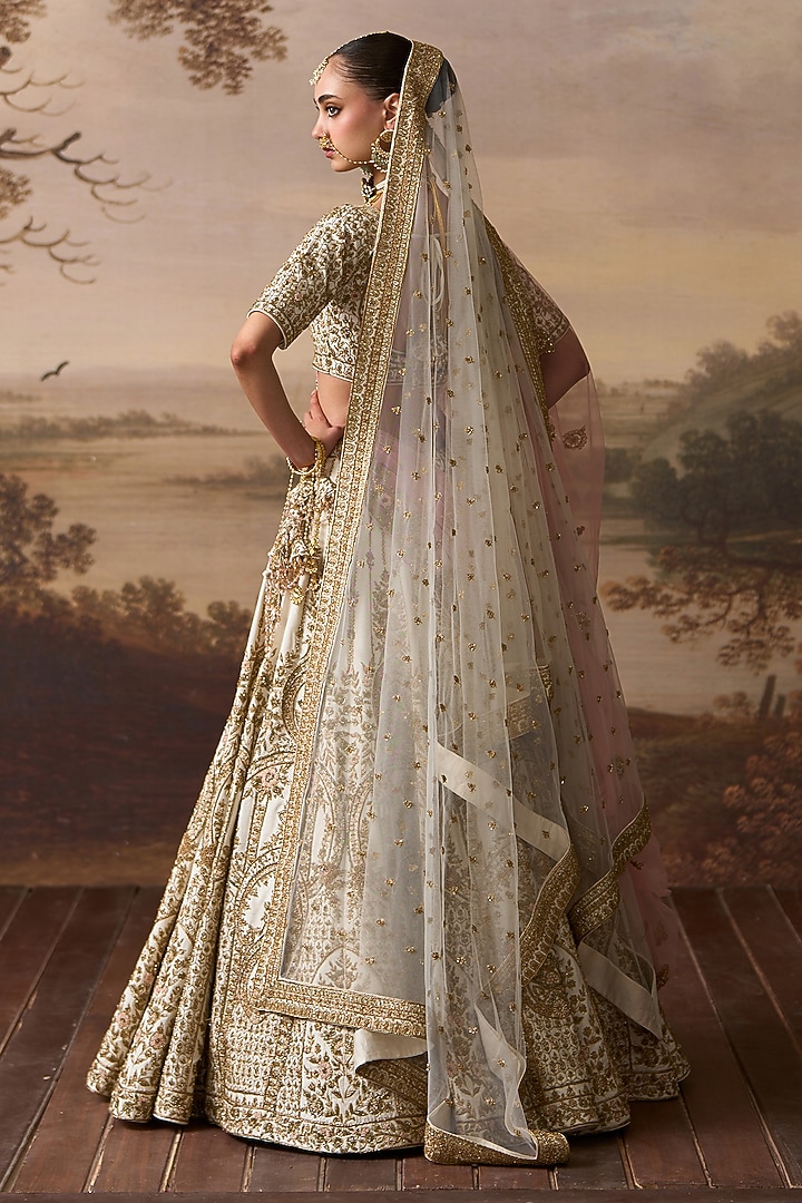 Ivory Raw Silk Floral Embroidered Bridal Lehenga Set by Angad Singh at Pernia's Pop Up Shop