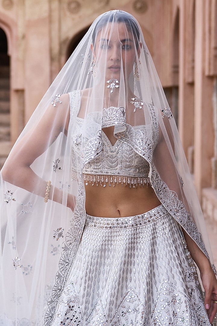Ivory Raw Silk Mirror Work Bridal Lehenga Set by Angad Singh at Pernia's Pop Up Shop