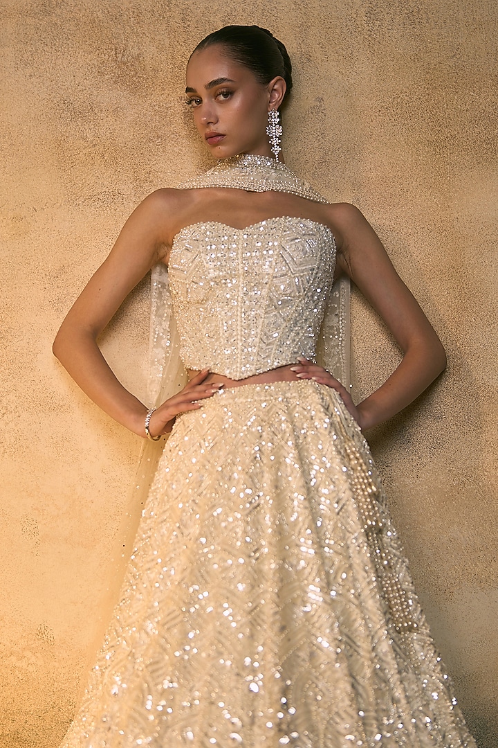 Ivory Net Embroidered Bridal Bridal Lehenga Set by Angad Singh at Pernia's Pop Up Shop