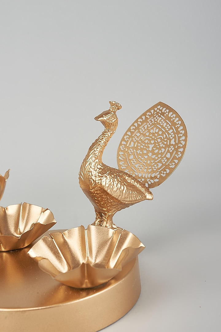 Gold Iron Lotus & Peacock Diya With Stand by The Khabiyas Trunk by KJ at Pernia's Pop Up Shop