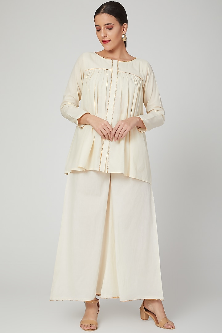 Beige Embroidered Palazzo Pants by THE LABEL UNTOLD