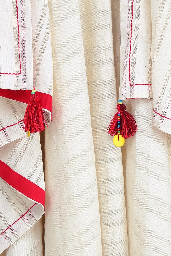 Off white asymmetric jacket with red tassel hangings available only at Pernia's Pop Up Shop.