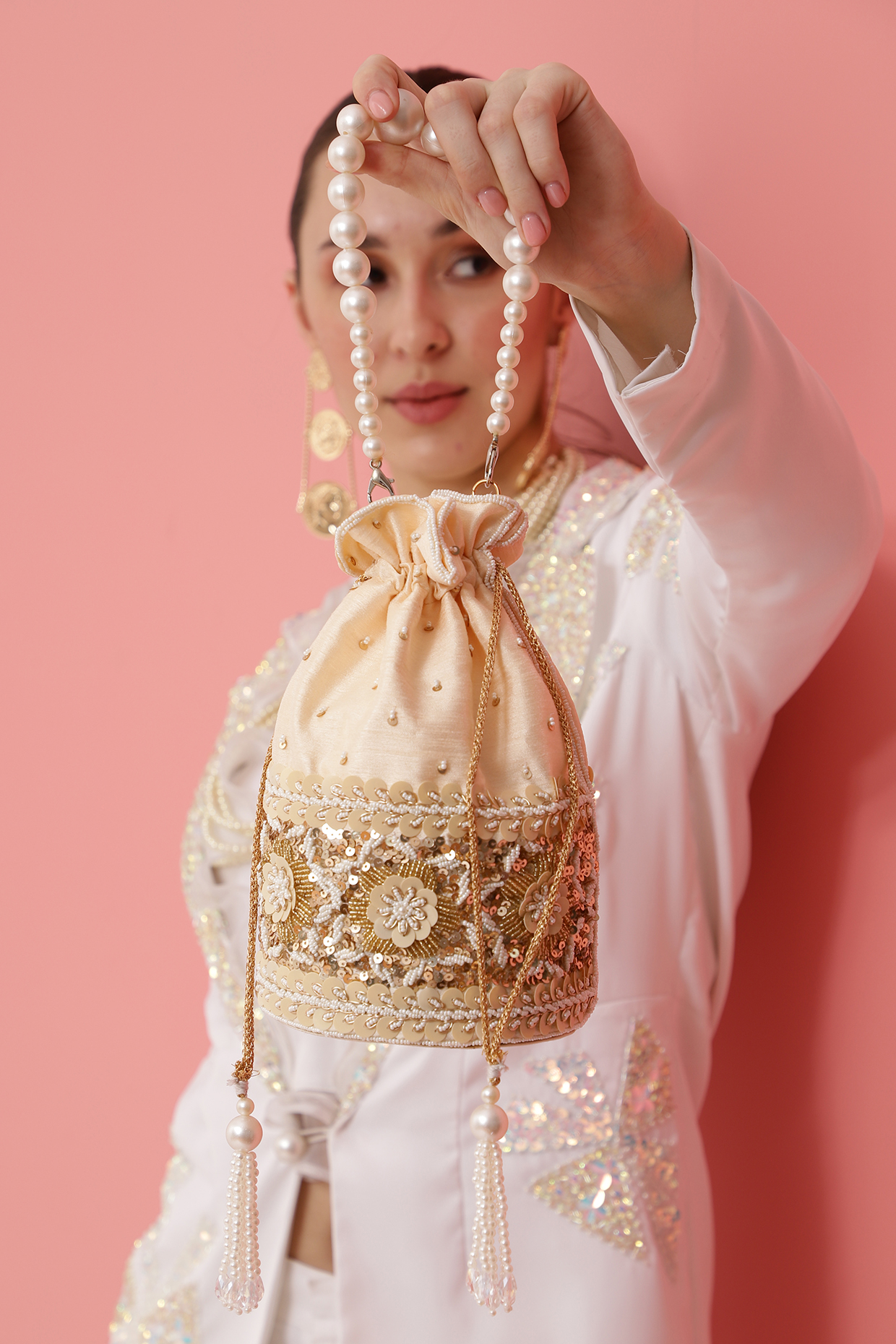 Gold Raw Silk Hand Embroidered Potli by THE TAN CLAN at Pernia's Pop Up Shop