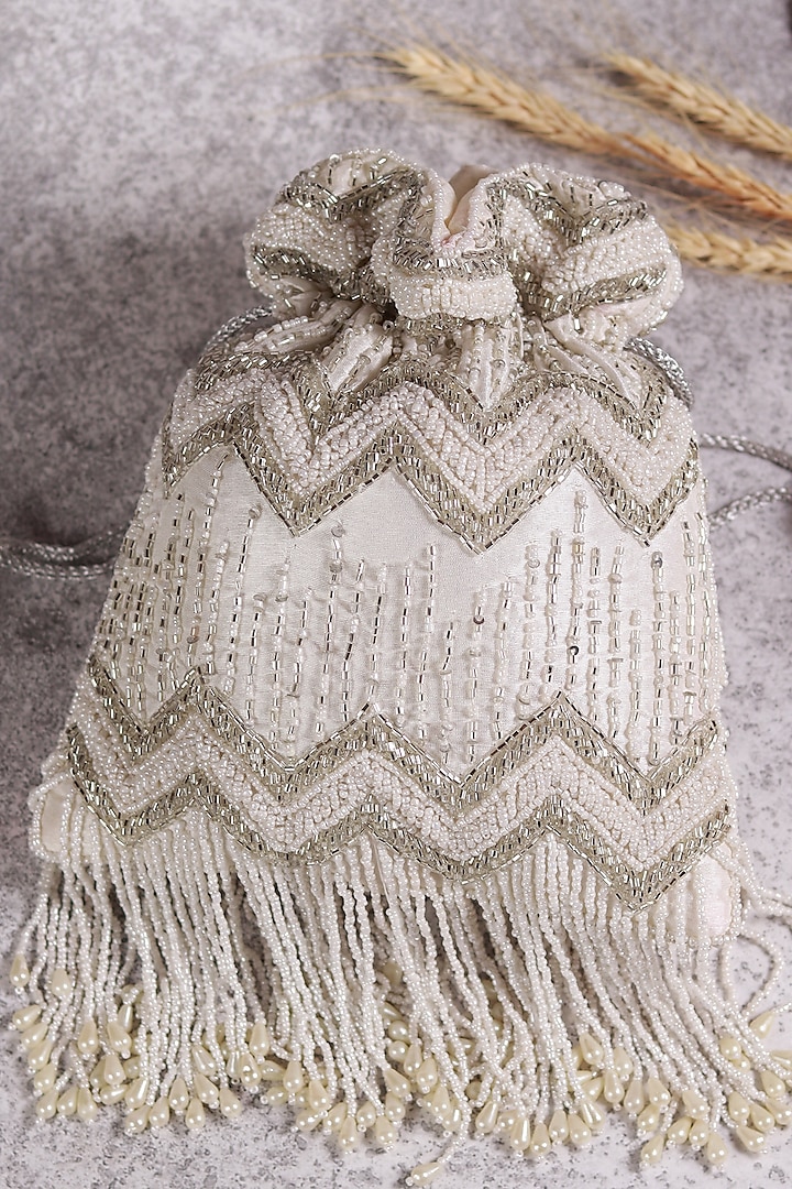 White Raw Silk Hand Embroidered Potli by THE TAN CLAN at Pernia's Pop Up Shop