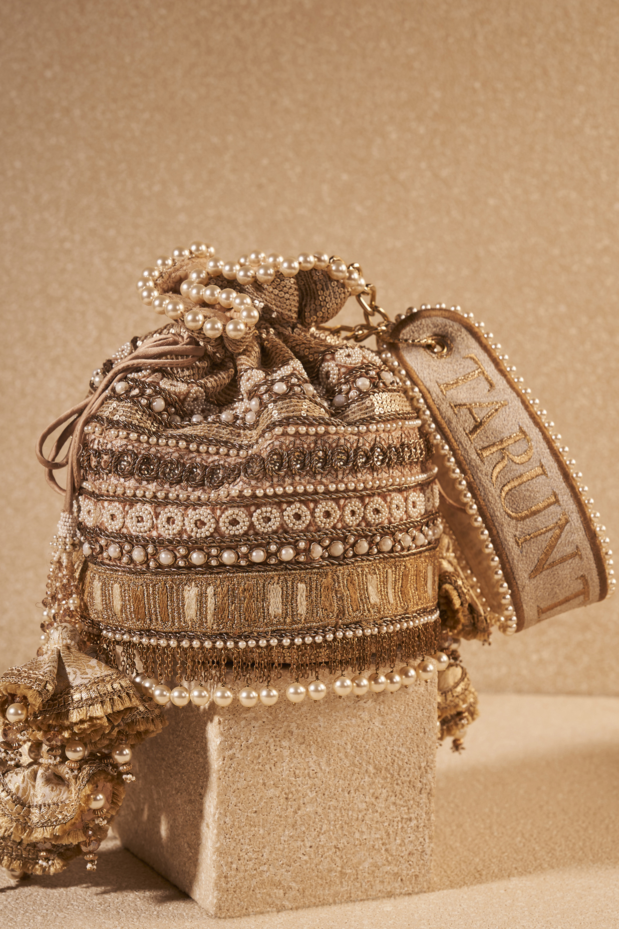 Ivory Gold Poly Dupion & Viscose Satin Hand Embroidered Potli Bag by Tarun Tahiliani Accessories at Pernia's Pop Up Shop