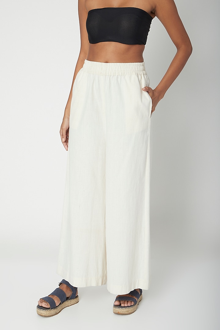 Ecru White Flared Pants by Urvashi Kaur at Pernia's Pop Up Shop