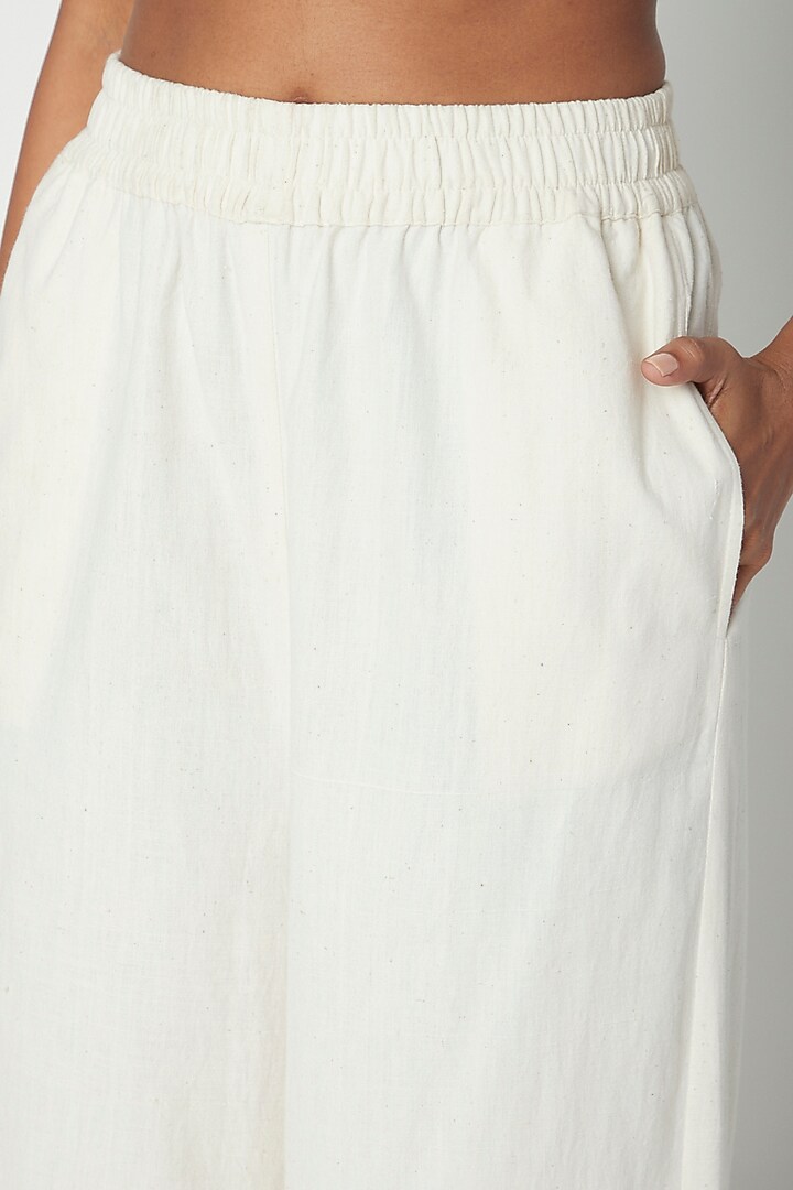 Ecru White Flared Pants by Urvashi Kaur at Pernia's Pop Up Shop