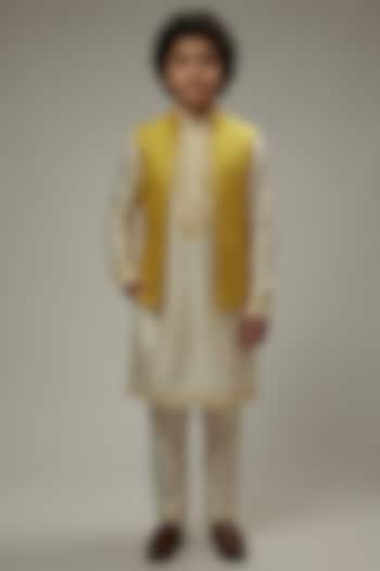 Yellow Dupion Silk Embroidered Bundi Jacket Set For Boys by Vanshik Kids at Pernia's Pop Up Shop