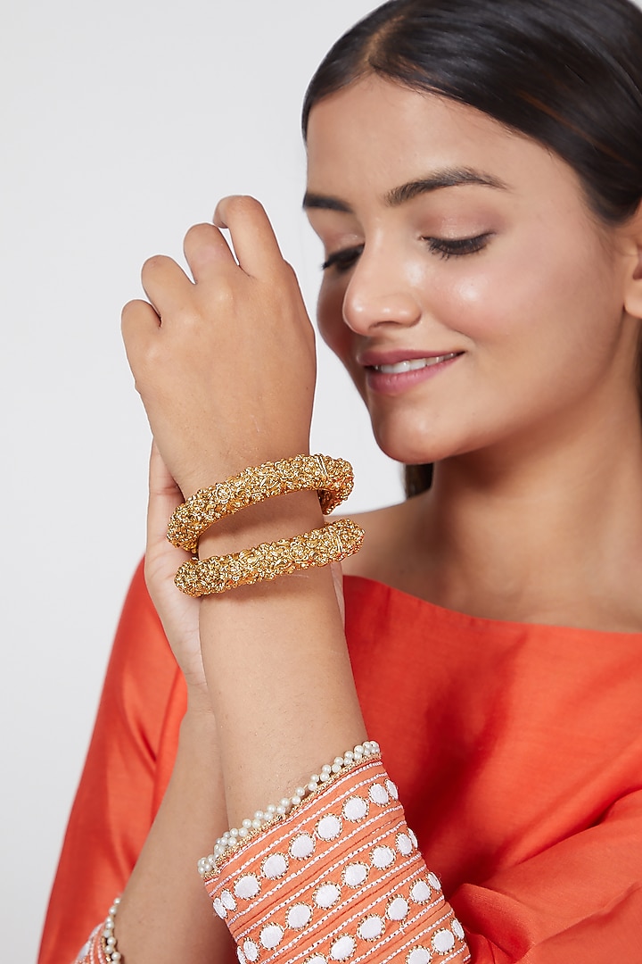 Gold Finish Carved Floral Bangles (Set of 2) by VASTRAA Jewellery at Pernia's Pop Up Shop