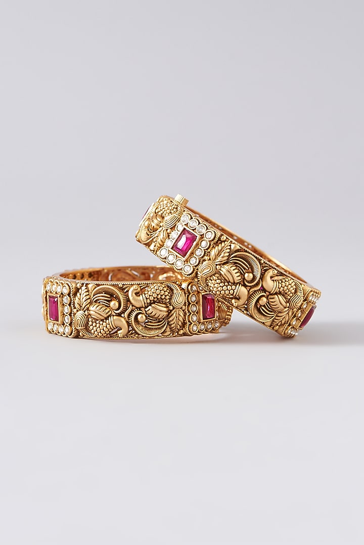 Gold Finish Kundan Polki & Red Stone Bangles (Set Of 2) by VASTRAA Jewellery at Pernia's Pop Up Shop
