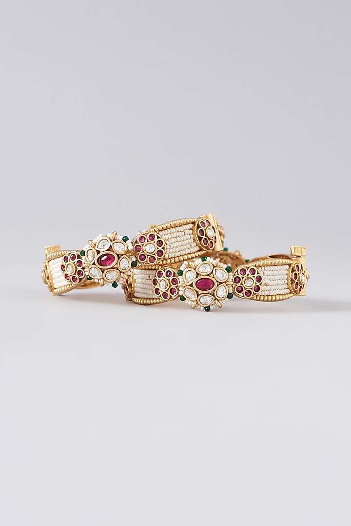 Gold Finish Kundan Polki & Red Stone Bangles (Set of 2) by VASTRAA Jewellery at Pernia's Pop Up Shop