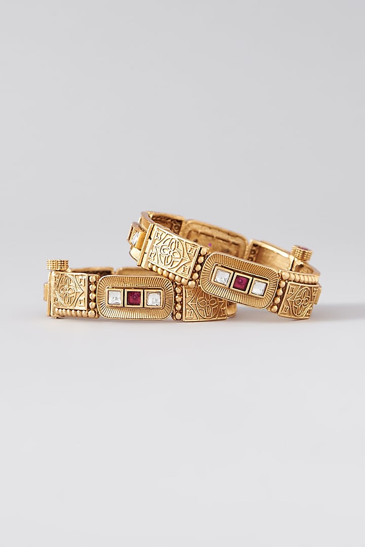 Gold Finish Kundan Polki & Red Stone Bangles (Set Of 2) by VASTRAA Jewellery at Pernia's Pop Up Shop