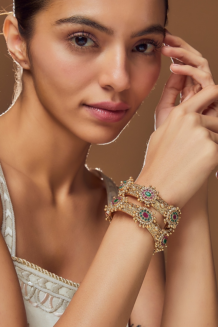 Gold Finish Kundan Polki & Multi-Colored Stone Temple Bangles (Set Of 2) by VASTRAA Jewellery at Pernia's Pop Up Shop